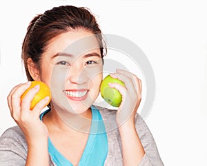 Young beautiful asian woman holding orange and apple,smile Health care concept