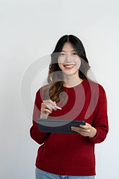 Young beautiful asian woman holding tablet digital tablet surfing internet smiling on white background