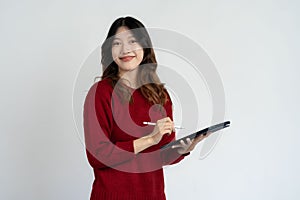 Young beautiful asian woman holding tablet digital tablet surfing internet smiling on white background