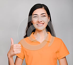 Young beautiful asian woman,long black hair, wore orange t shirt,smile and