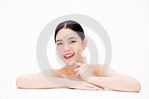 Young beautiful Asian woman showing off smooth and lifting facial health in white isolated background - rejuvenation and anti