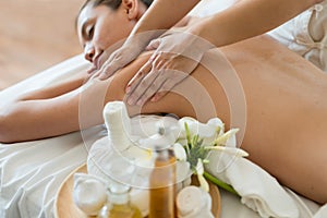 Young beautiful Asian woman sleep relaxing in the Oil spa massage in salon. Select focus hand of masseuse.