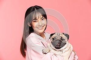 Young Beautiful Asian woman smile with clean and fresh skin Happiness and cheerful hold cute dog breed pug