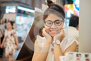 Young beautiful asian woman smiling when looking menu dinner time in restaurant or coffee shop