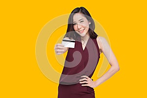 Young beautiful Asian woman smiling and show credit card.