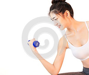 Young beautiful asian woman wearing a white tank top Exercise with pink yoga ball, orange juice and drinking water holding blue