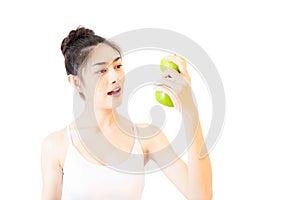 Young beautiful asian woman wearing a white tank top Exercise with pink yoga ball, orange juice and drinking water holding blue