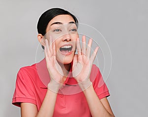 Young beautiful asian woman wore pink t shirt, Showed The announcement  expression , on gray background photo