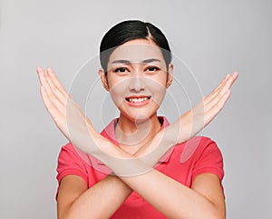 Young beautiful asian woman wore pink t shirt, Showed Crossed hands and smile photo