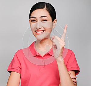 Young beautiful asian woman wore pink t shirt, Showed idea expression , on gray background