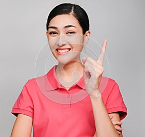 Young beautiful asian woman wore pink t shirt, Showed idea expression , on gray background photo