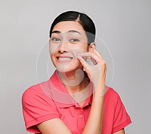 Young beautiful asian woman wore pink t shirt, Showed Keep quiet expression , on gray background