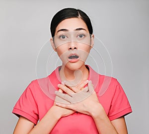 Young beautiful asian woman wore pink t shirt, Showed Shocked expression , on gray background photo