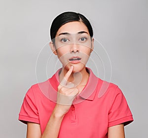 Young beautiful asian woman wore pink t shirt, Showed Surprised and Thinking expression , on gray background