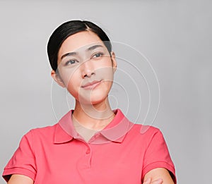 Young beautiful asian woman wore pink t shirt, Showed thinking expression , on gray background