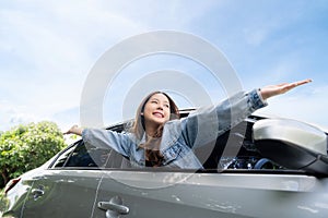 Young beautiful asian women getting new car. She relaxing out of window in a car - Freedom car travel concept