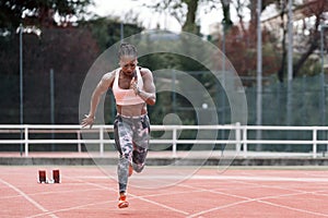 Young beautiful athlete sprinter running