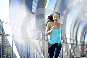 young beautiful athletic sport woman running and jogging crossing modern metal city bridge