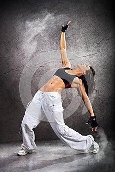 Young beautiful athletic woman dancing modern dance