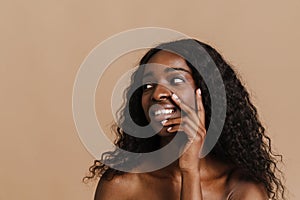 Young beautiful attractive african naked smiling woman touching her face