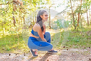 Young beautiful attractive sport runner woman tying her shoe sneaker smiling happy ready for running and jogging summer