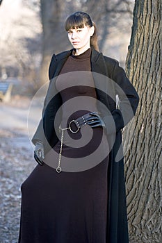 Young beautiful attractive woman in dress and coat
