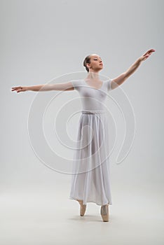 Young and beautiful ballet dancer posing isolated