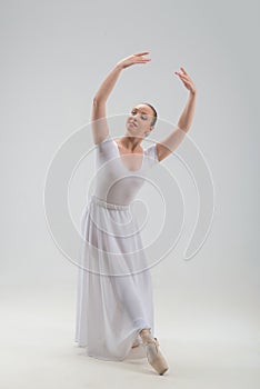 Young and beautiful ballet dancer posing isolated