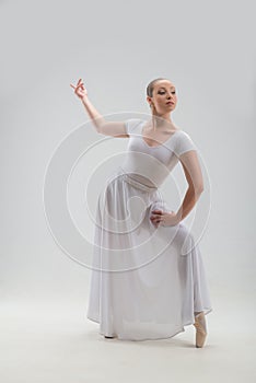 Young and beautiful ballet dancer posing isolated