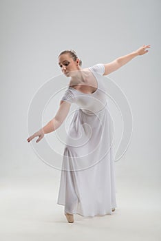 Young and beautiful ballet dancer posing isolated