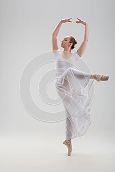 Young and beautiful ballet dancer posing isolated