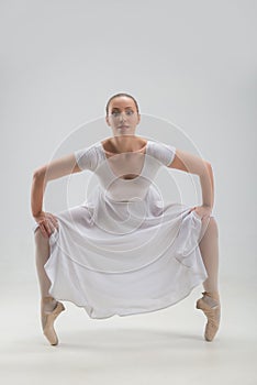 Young and beautiful ballet dancer posing isolated