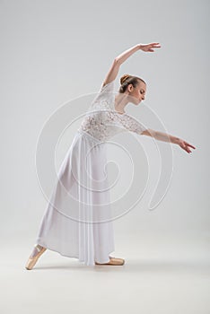 Young and beautiful ballet dancer posing isolated