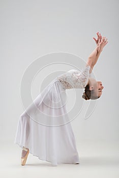 Young and beautiful ballet dancer posing isolated