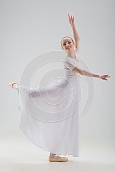 Young and beautiful ballet dancer posing isolated