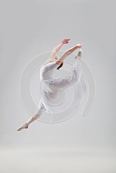 Young and beautiful ballet dancer posing isolated