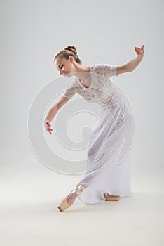 Young and beautiful ballet dancer posing isolated