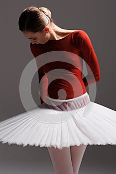 Young beautiful ballet dancer posing in a studio