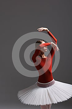 Young beautiful ballet dancer posing in a studio