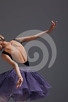 Young beautiful ballet dancer posing in a studio