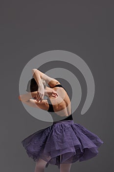 Young beautiful ballet dancer posing in a studio