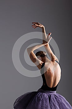 Young beautiful ballet dancer posing in a studio