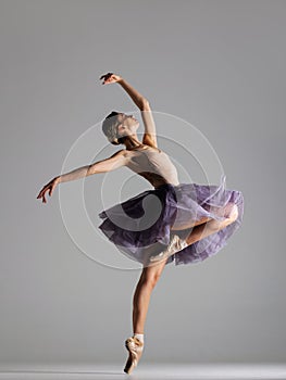 Young beautiful ballet dancer posing in a studio