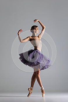 Young beautiful ballet dancer posing in a studio