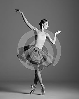 Young beautiful ballet dancer posing in a studio