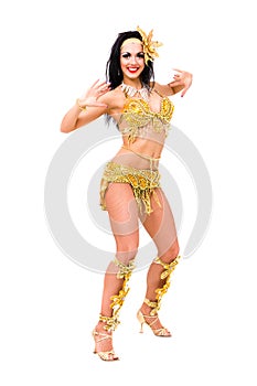 Young beautiful belly dancer in a gold costume
