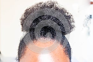 Young beautiful black girl with natural Afro Kinky hair bun. African American Kinky curly woman with cute bun for creative elegant