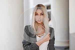 Young beautiful blond girl in vintage gray jacket photo