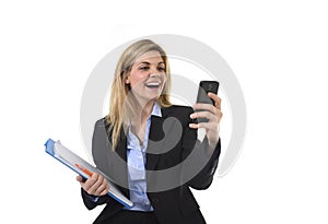 Young beautiful blond hair businesswoman using internet app on mobile phone holding office folder and pen smiling happy