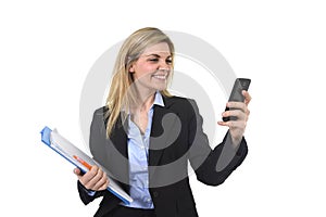 Young beautiful blond hair businesswoman using internet app on mobile phone holding office folder and pen smiling happy